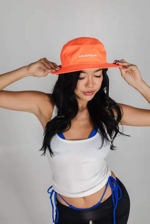 AQUATIQUE Neon Orange bucket hat, worn in the studio