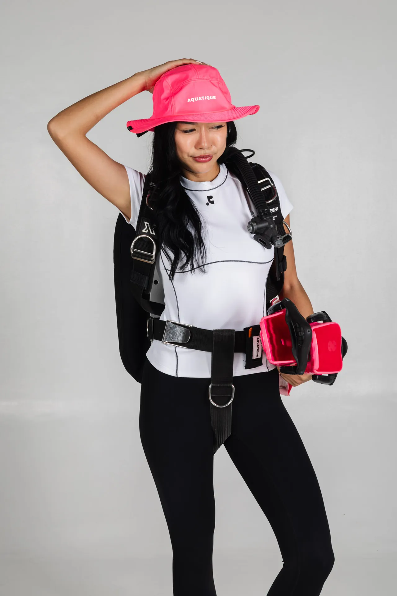 AQUATIQUE Neon Pink bucket hat, worn in the studio