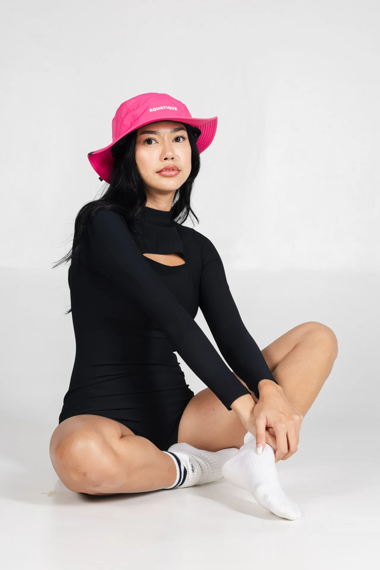 AQUATIQUE Shock Pink bucket hat, worn in the studio